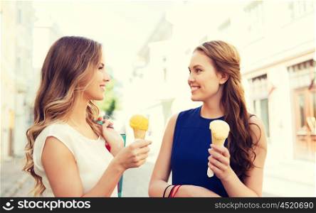 sale, consumerism, summer and people concept - happy young women with shopping bags and ice cream talking on city street
