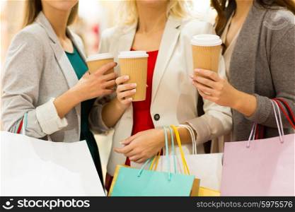 sale, drinks, consumerism and people concept - close up of women with shopping bags and coffee cups