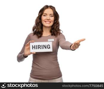 sale, employment and business concept - happy female shop assistant with hiring banner over white background. happy female shop assistant with hiring banner