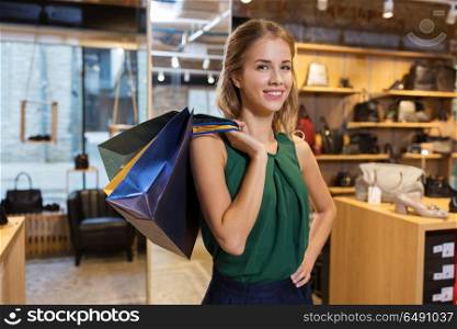 sale, fashion and people concept - happy young woman with shopping bags at at at shoestore. happy young woman with shopping bags at shoestore. happy young woman with shopping bags at shoestore