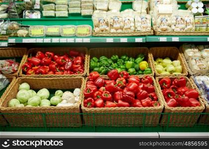sale, food and vegetables concept - bell peppers or paprika at grocery store
