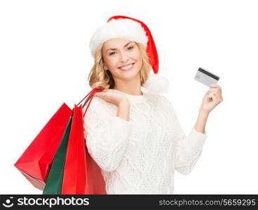 sale, gifts, christmas, x-mas concept - smiling woman in santa helper hat with shopping bags and credit card