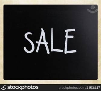 ""Sale" handwritten with white chalk on a blackboard"