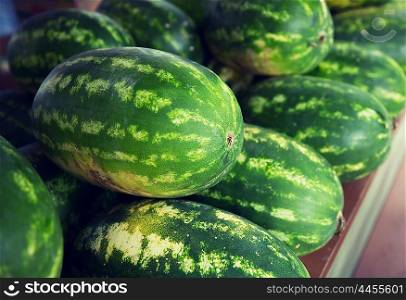 sale, harvest, food, fruits and agriculture concept - close up of watermelon at street farmers market