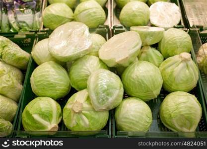 sale, harvest, food, vegetables and agriculture concept - close up of cabbage at grocery store or market