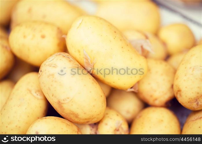 sale, harvest, food, vegetables and agriculture concept - close up of potato at street market