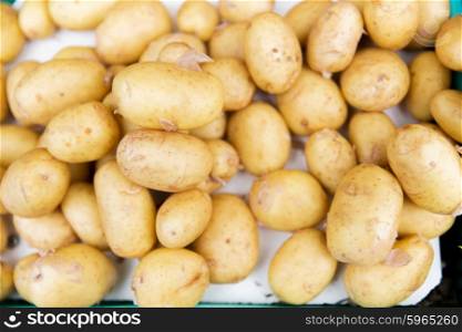 sale, harvest, food, vegetables and agriculture concept - close up of potato at street market