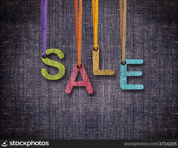 Sale letters hanging strings with blue sackcloth background.. Sale