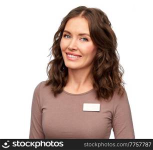 sale, shopping and business concept - happy female shop assistant with name tag over white background. happy female shop assistant with name tag