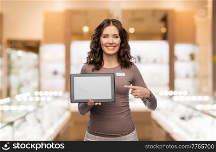 sale, shopping and business concept - happy female shop assistant with tablet pc computer name tag over jewelry store background. happy female jewelry shop assistant with tablet pc