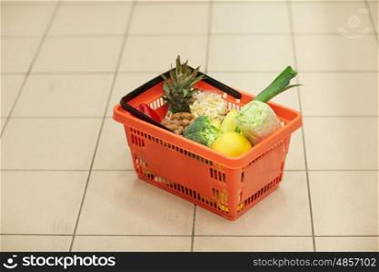 sale, shopping and consumerism concept - food basket on grocery or supermarket floor