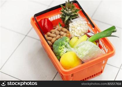 sale, shopping and consumerism concept - food basket on grocery or supermarket floor. food basket on grocery or supermarket floor. food basket on grocery or supermarket floor