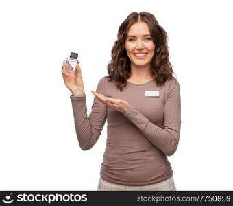 sale, shopping and perfumery concept - happy female shop assistant with perfume over white background. happy female shop assistant with perfume