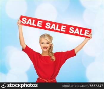 sale, shopping, christmas, holidays and people concept - smiling woman in red dress with red sale sign over blue lights background