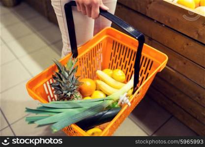 sale, shopping, consumerism and people concept - close up of young woman with food basket in market