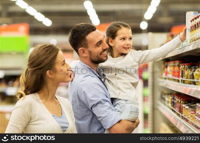 sale, shopping, consumerism and people concept - happy family with child buying food at grocery store or supermarket. happy family buying food at grocery store