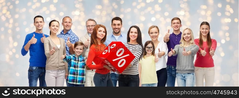 sale, shopping, family, generation and people concept - group of happy men and women showing thumbs up and percent sign over holidays lights background