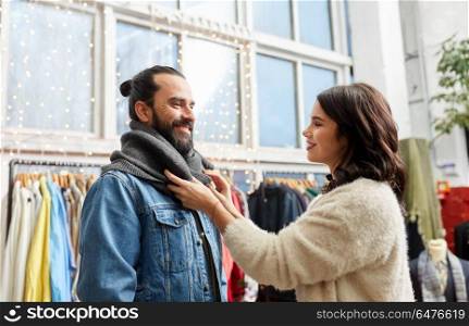 sale, shopping, fashion and people concept - couple choosing clothes at vintage clothing store. couple choosing clothes at vintage clothing store. couple choosing clothes at vintage clothing store