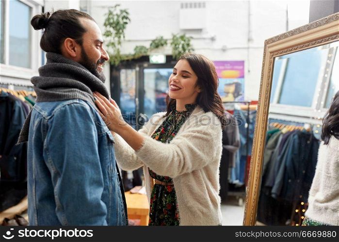 sale, shopping, fashion and people concept - couple choosing clothes at vintage clothing store. couple choosing clothes at vintage clothing store. couple choosing clothes at vintage clothing store