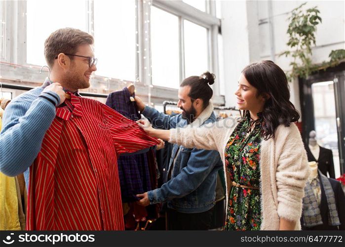 sale, shopping, fashion and people concept - friends choosing clothes at vintage clothing store. friends choosing clothes at vintage clothing store. friends choosing clothes at vintage clothing store