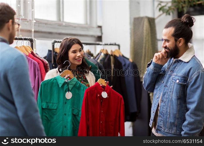 sale, shopping, fashion and people concept - happy friends choosing clothes at vintage clothing store. friends choosing clothes at vintage clothing store. friends choosing clothes at vintage clothing store