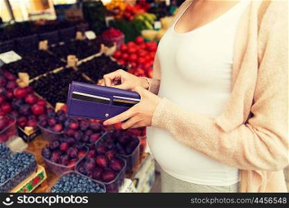 sale, shopping, pregnancy and people concept - close up of pregnant woman with wallet and and credit cards buying food at street market