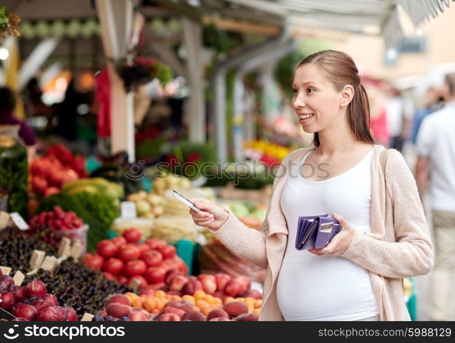 sale, shopping, pregnancy and people concept - happy pregnant woman with wallet and credit card buying food at street market