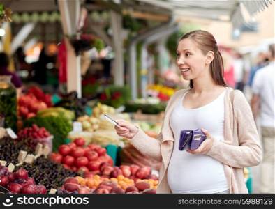 sale, shopping, pregnancy and people concept - happy pregnant woman with wallet and credit card buying food at street market
