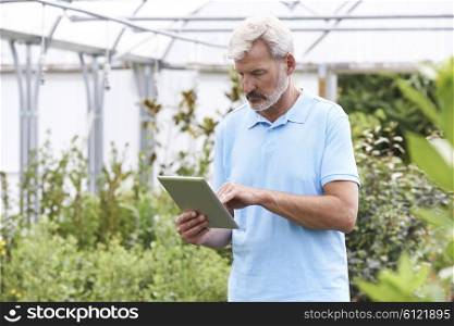 Sales Assistant In Garden Center With Digital Tablet