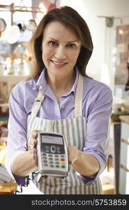 Sales Assistant In Homeware Store With Credit Card Machine