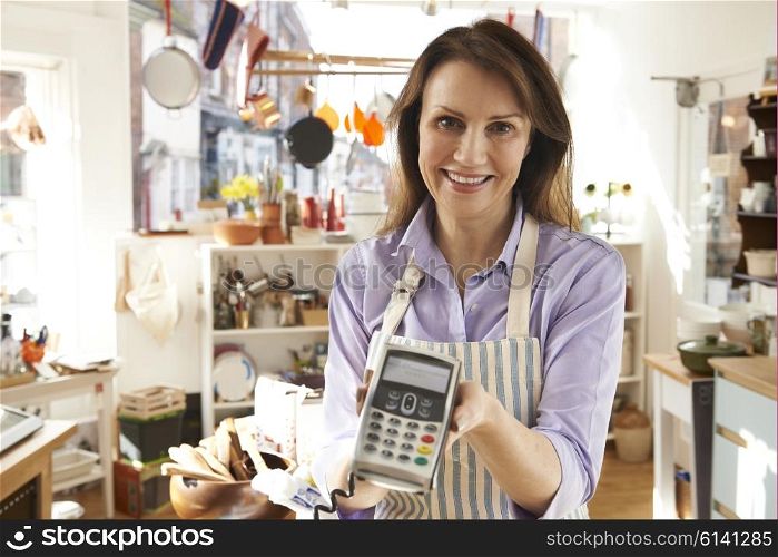 Sales Assistant In Homeware Store With Credit Card Machine