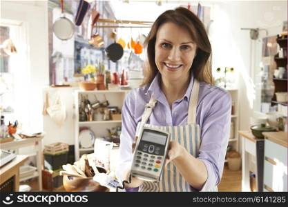 Sales Assistant In Homeware Store With Credit Card Machine