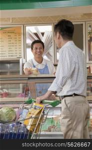 Sales Clerk assisting man at the Deli counter, Beijing