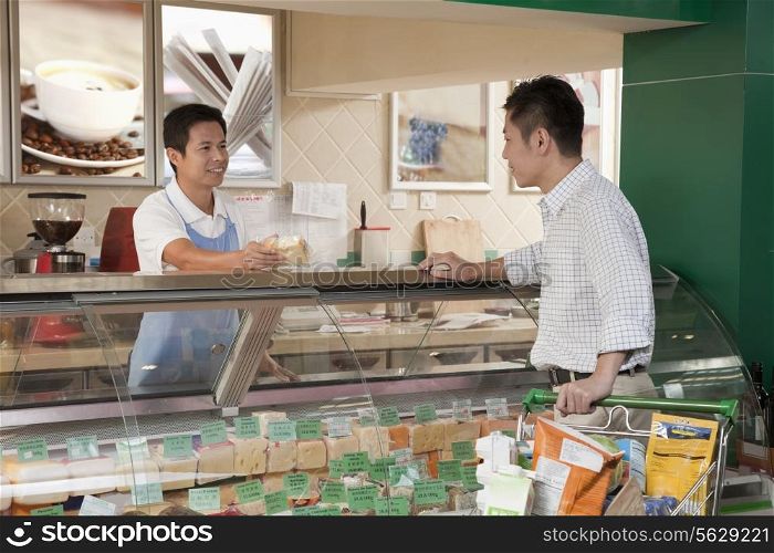 Sales Clerk assisting man at the Deli counter, Beijing