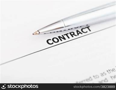 sales contract and silver pen close up
