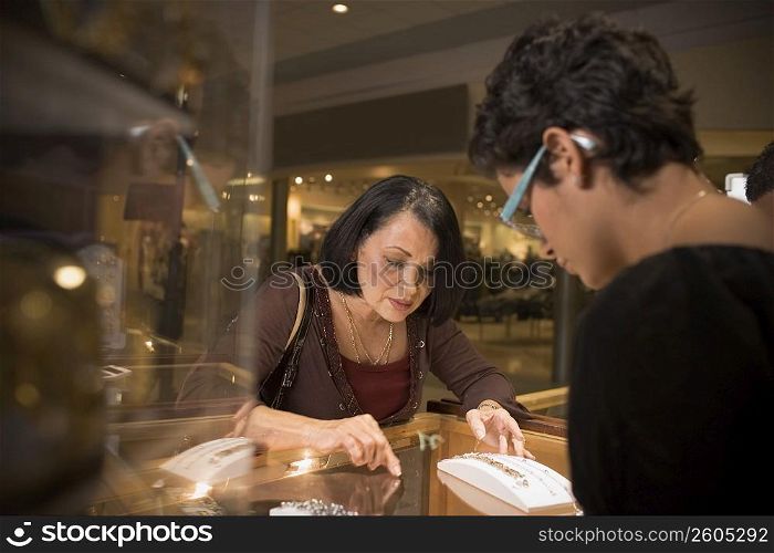 Sales girl at jewelry store helping customer