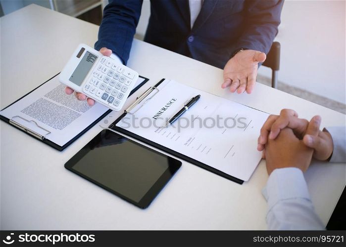 Sales manager giving advice application form document, considering mortgage loan offer for car and house insurance