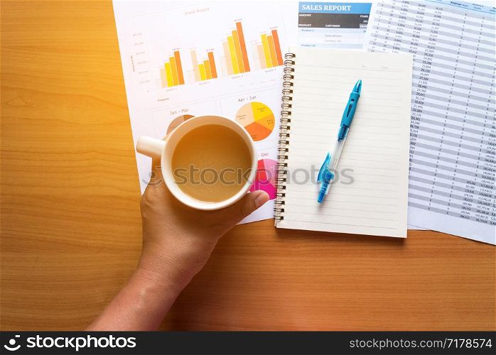Sales Managers Working Modern Studio.Woman Showing Hand Market Report Charts.Marketing Department Planning New Strategy.Researching Process Wood Table.Horizontal.Blurred Background.Film effect.