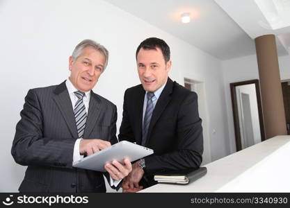 Sales people working on electronic tablet