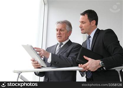 Sales people working on electronic tablet