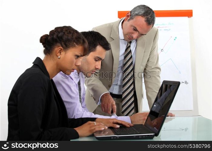 Sales team working at laptops