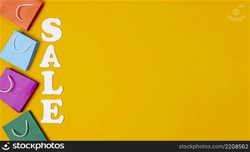 sales with paper bags concept orange background copy space
