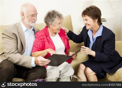 Sales woman making an aggressive pitch to a senior couple. The husband is skeptical.