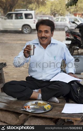 Salesman drinking water and smiling