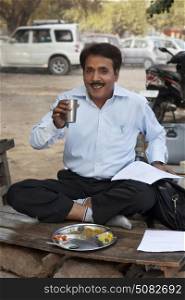 Salesman drinking water and smiling