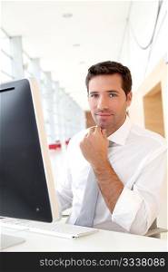 Salesman in front of desktop computer