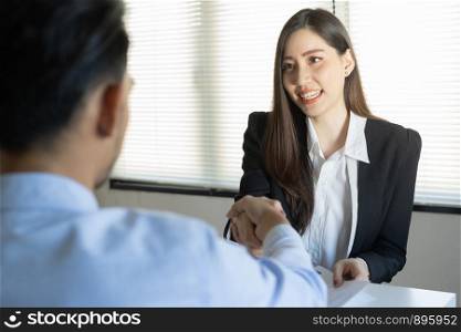 Salesman shaking hand with male customers in her office in the home trading agreement. Asian women and man smile happiness