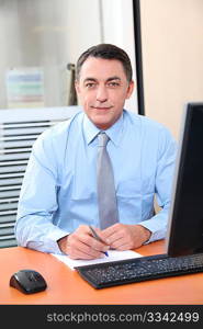 Salesman working in front of computer