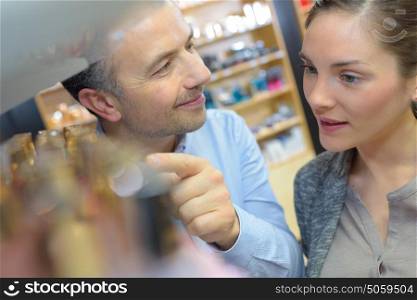saleswoman and man shopping for girlfriend