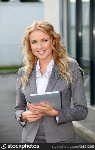 Saleswoman using mobile phone and digital tablet